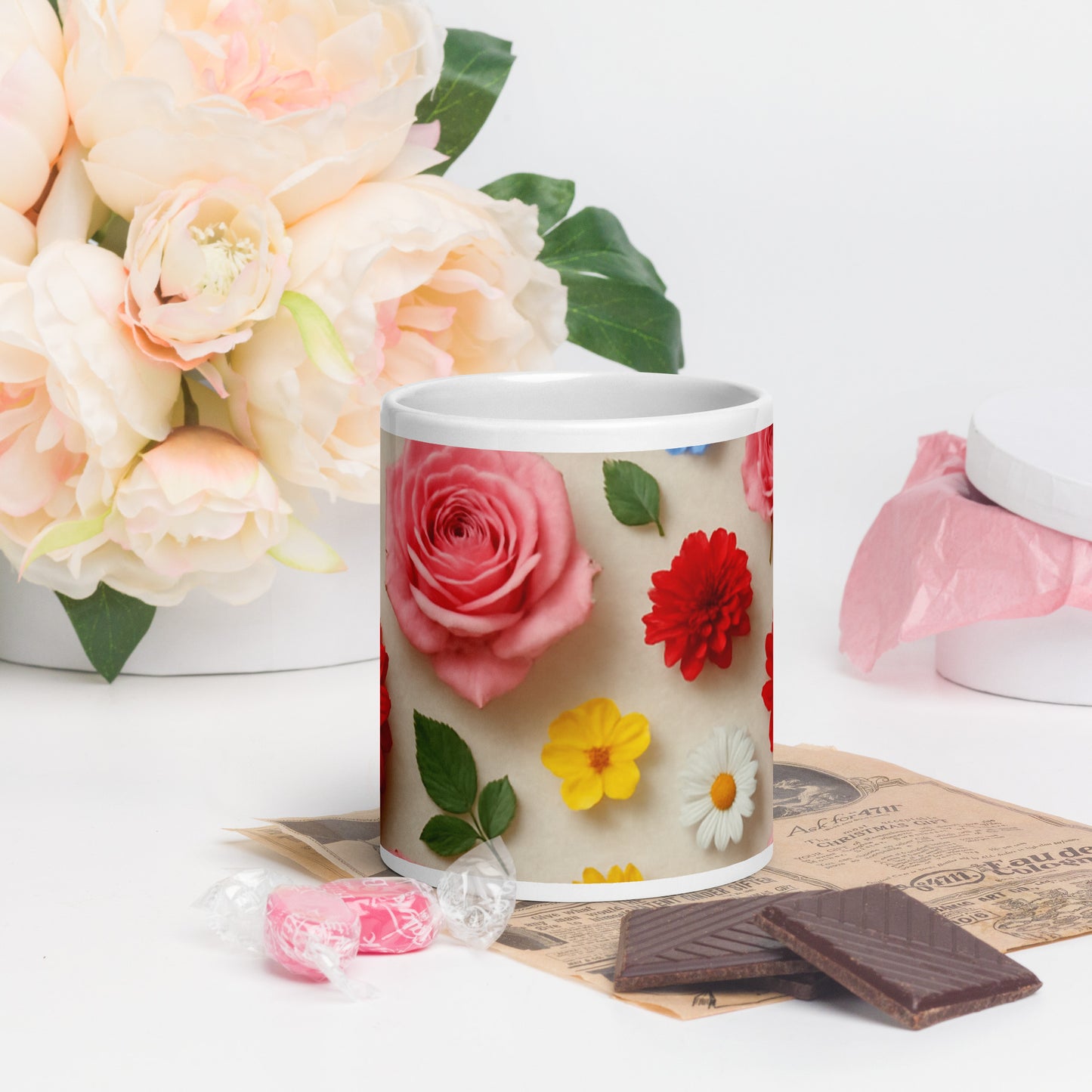Custom printed ceramic mug with colorful flower designs by PJ Designs placed next to chocolates and candy