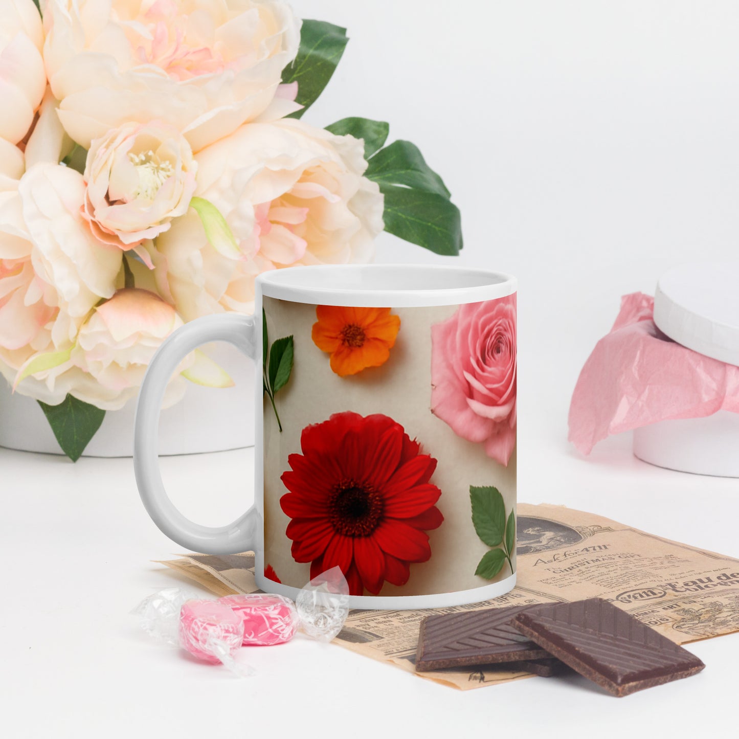 PJ Designs custom printed ceramic mug with red, pink, and orange floral all over prints displayed with candy and chocolate