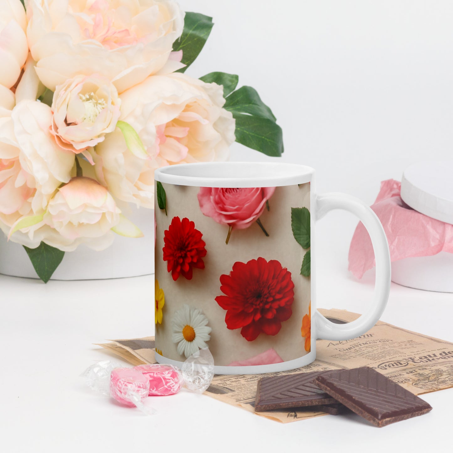 PJ Designs custom printed ceramic mug with colorful all over flower prints beside chocolates and candy