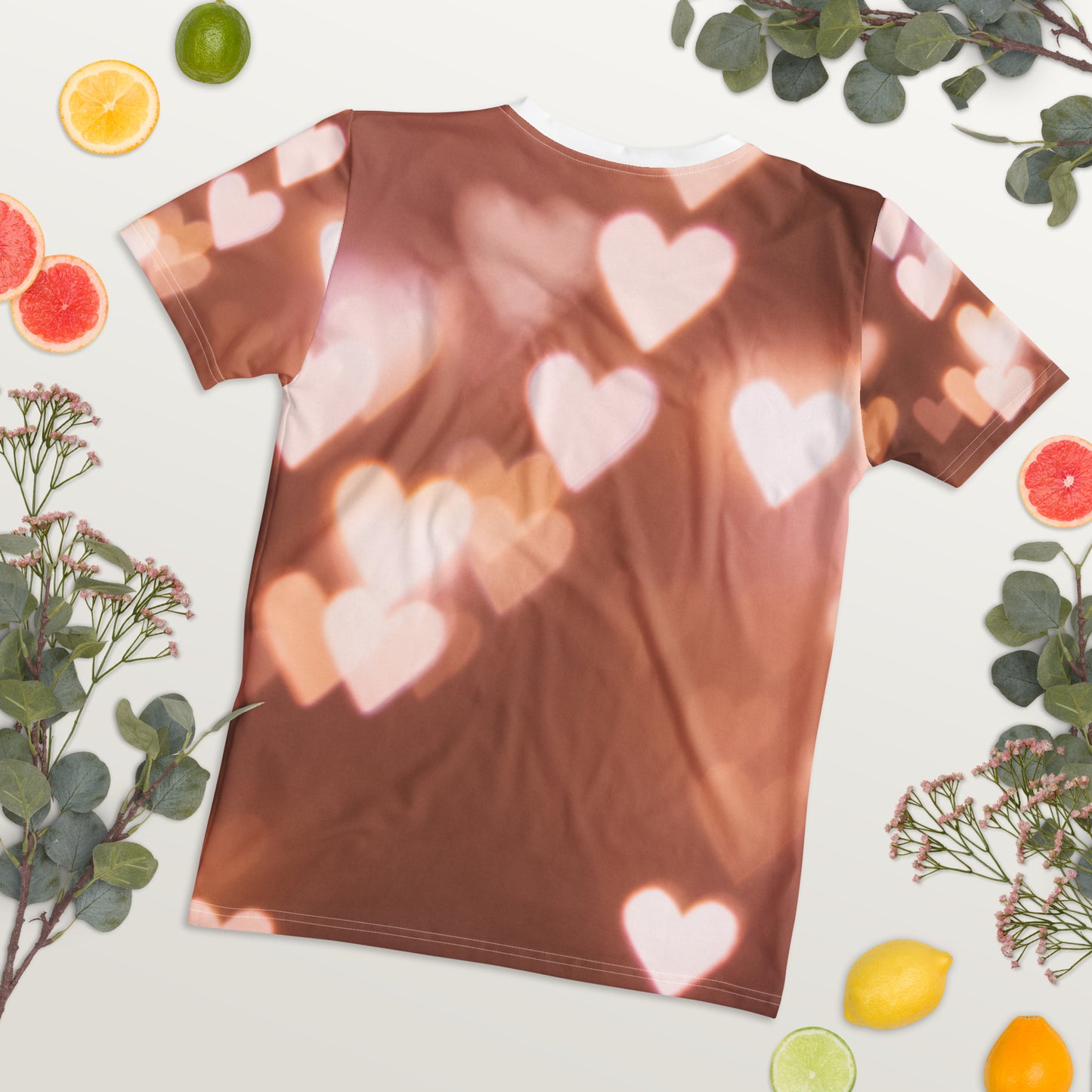 PJ Designs cute pink fitted tee with heart pattern laid flat surrounded by citrus fruits and greenery