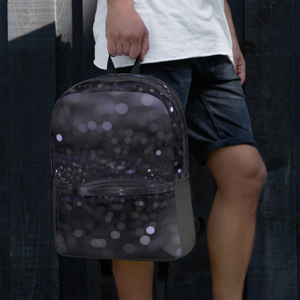 PJ Designs fashionable backpack with unique design held by person in white shirt and black shorts