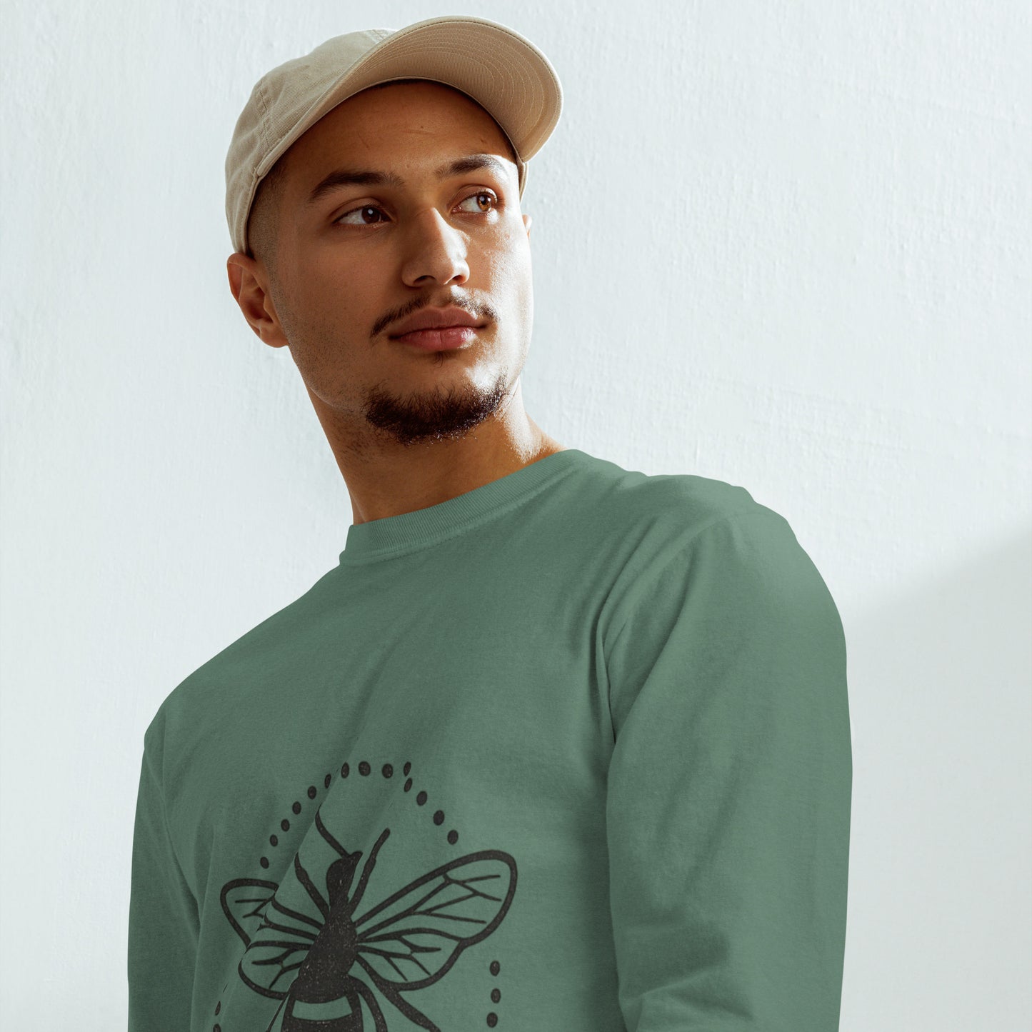 Man wearing PJ Designs garment-dyed heavyweight long sleeve shirt with bee graphic in sage green