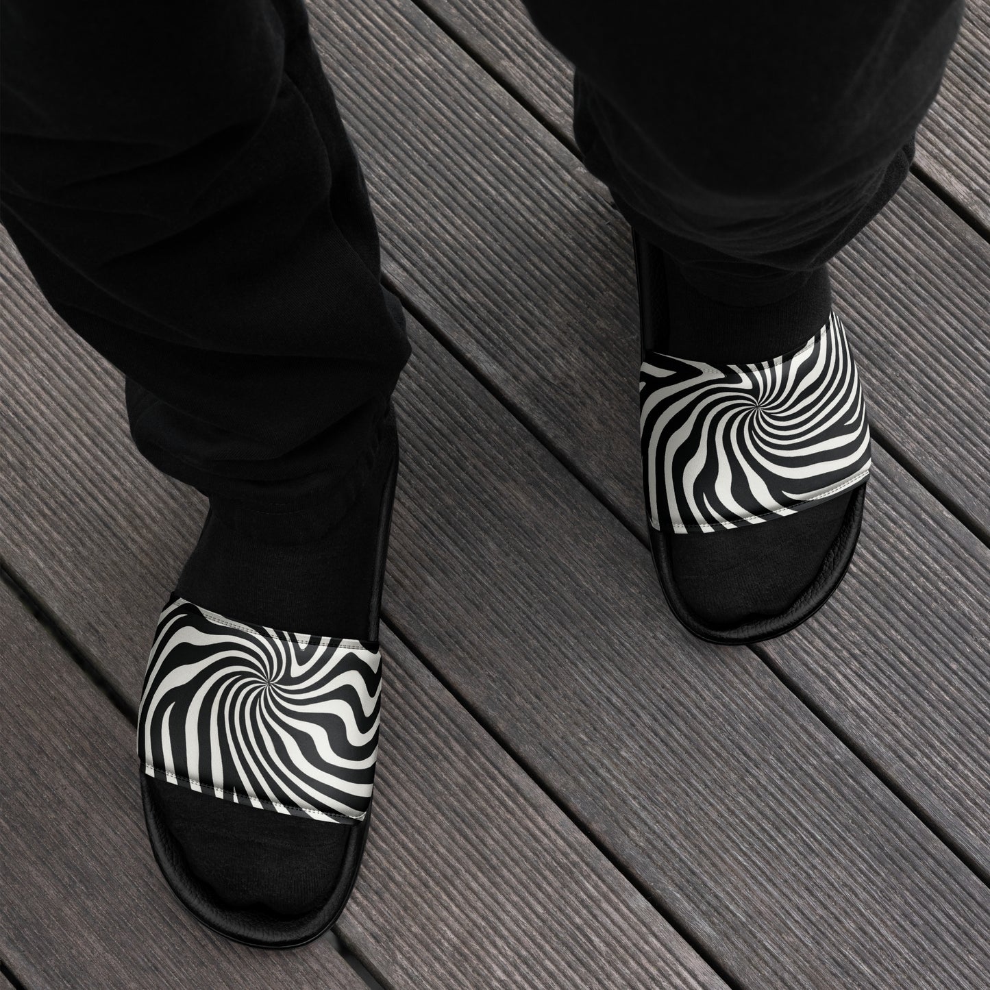 PJ Designs streetwear slides for men with black and white swirl pattern worn on wooden deck