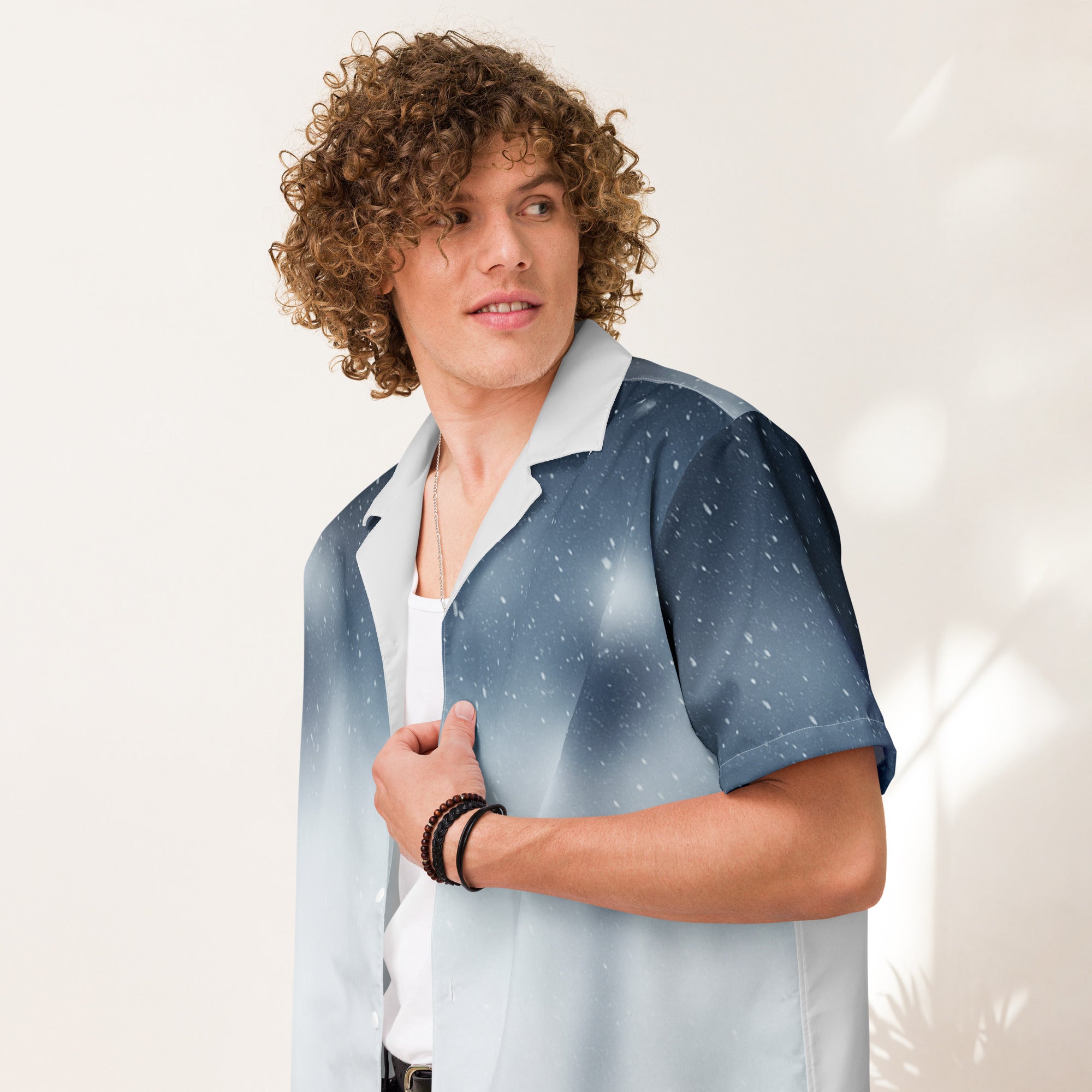 PJ Designs unisex casual button shirt in blue and white with short sleeves worn by a curly haired man