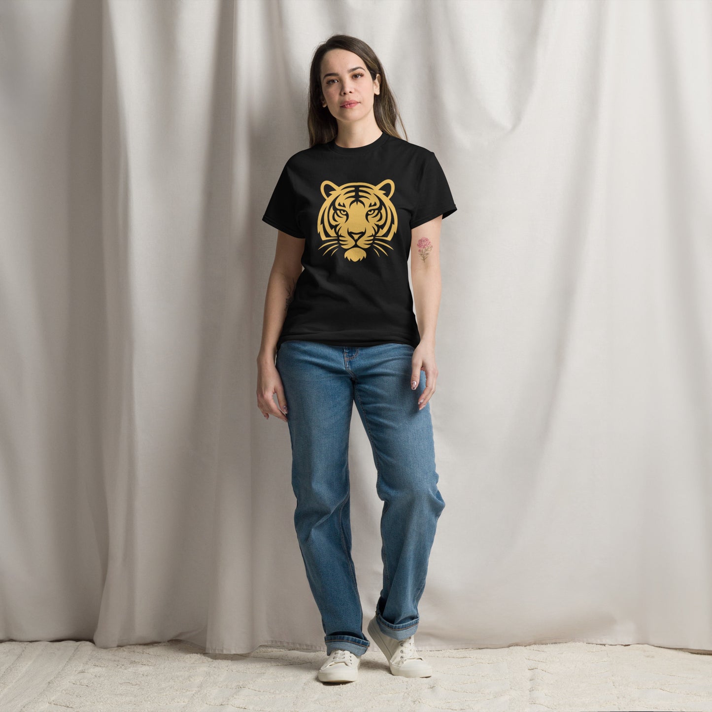 PJ Designs woman modeling black tiger graphic tee for men and women with gold tiger print jeans and sneakers