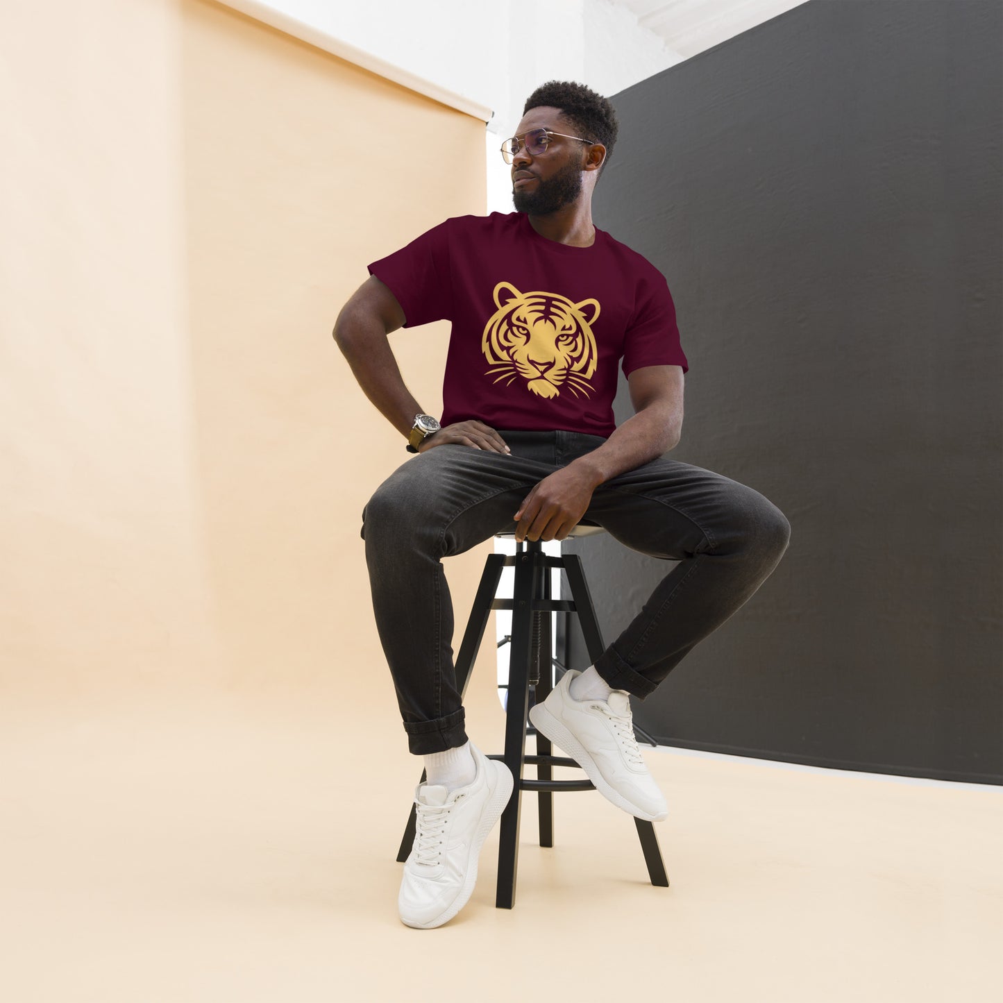 PJ Designs maroon shirt with gold tiger print worn by seated model in studio tiger graphic tee for men and women