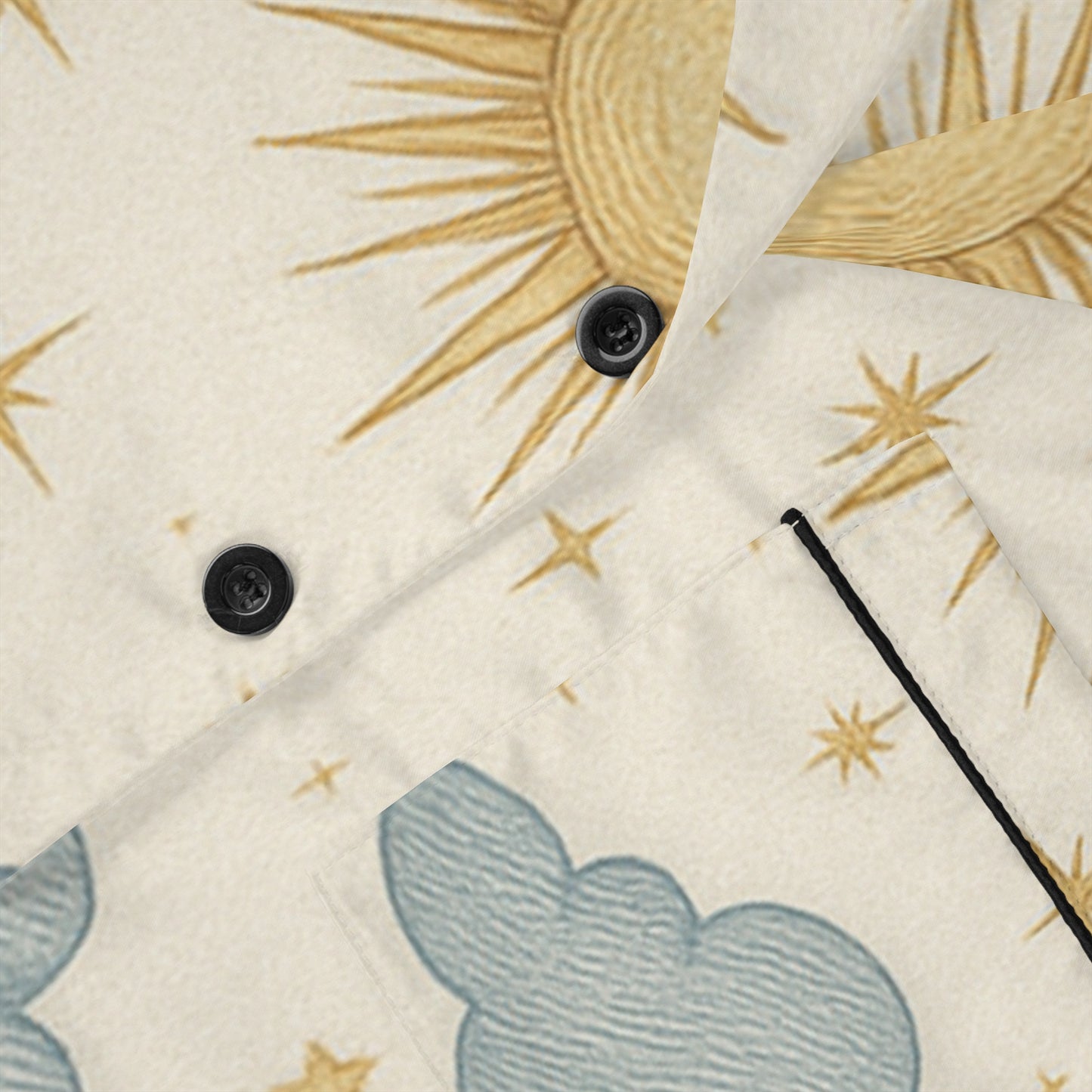 Close-up of women's satin pajamas set by PJ Designs featuring sun and cloud all over prints with black buttons