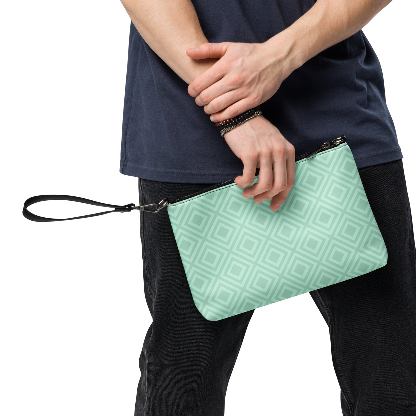 Man holding diamond pattern wristlet bag by PJ Designs with a light green all over print design