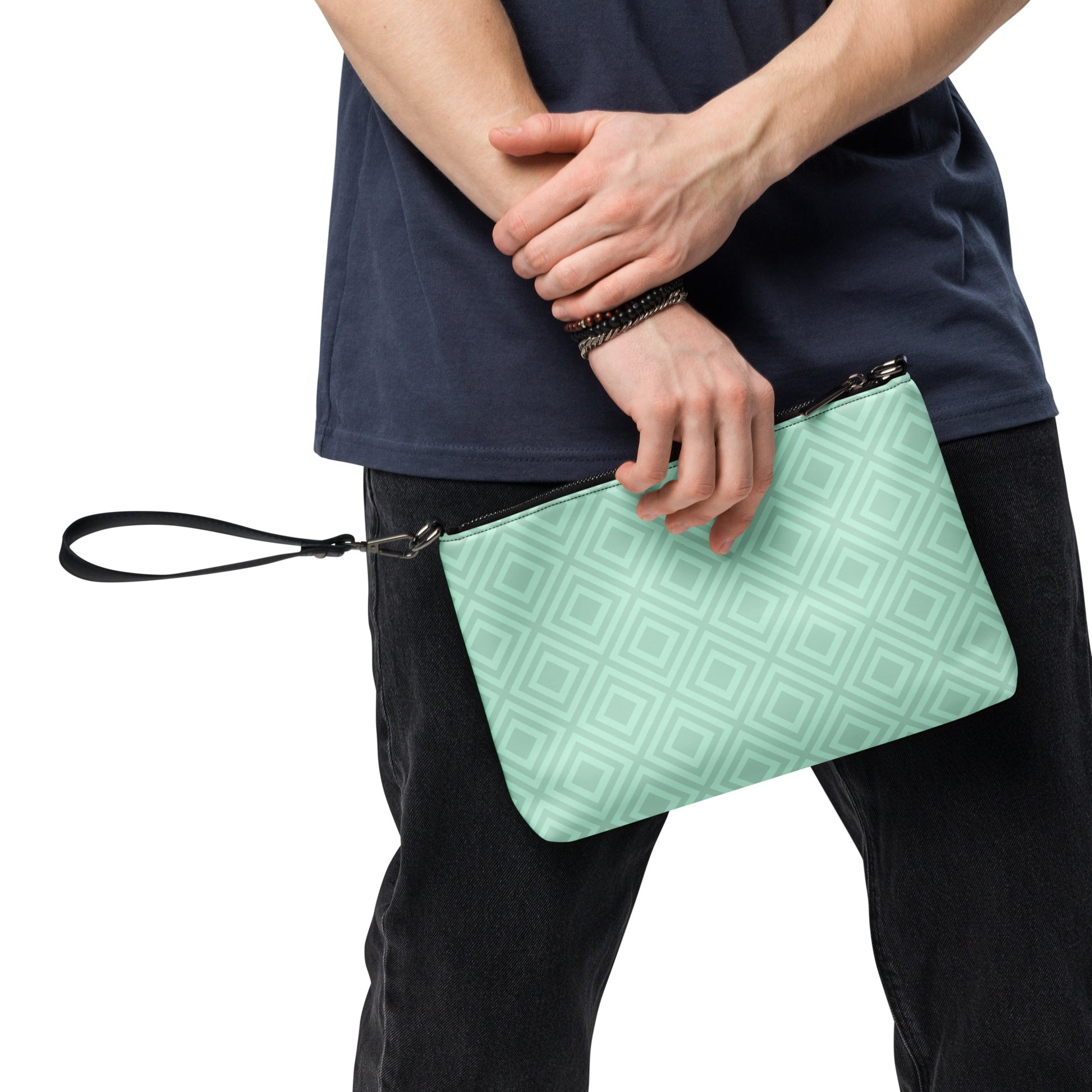 Man holding diamond pattern wristlet bag by PJ Designs with a light green all over print design