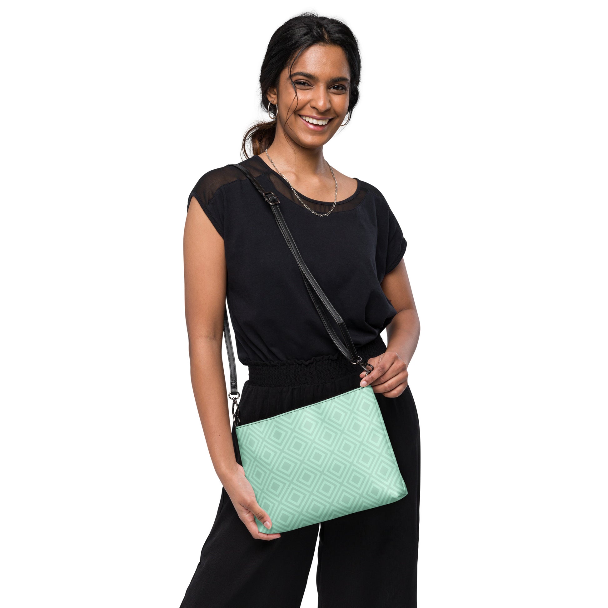 Woman wearing black outfit holding diamond pattern wristlet bag by PJ Designs with adjustable strap