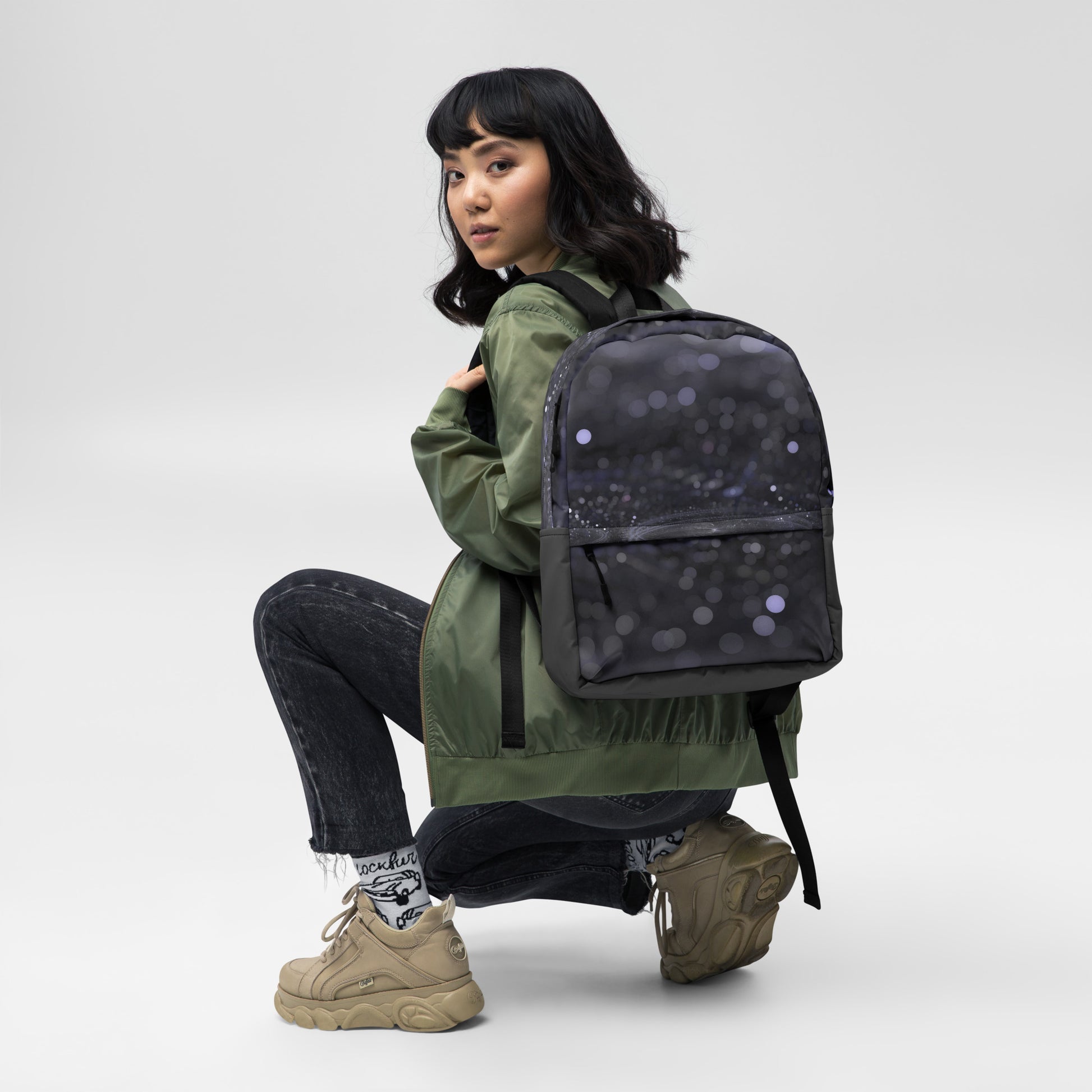 Fashionable backpack with unique design by PJ Designs worn by woman in green jacket and sneakers