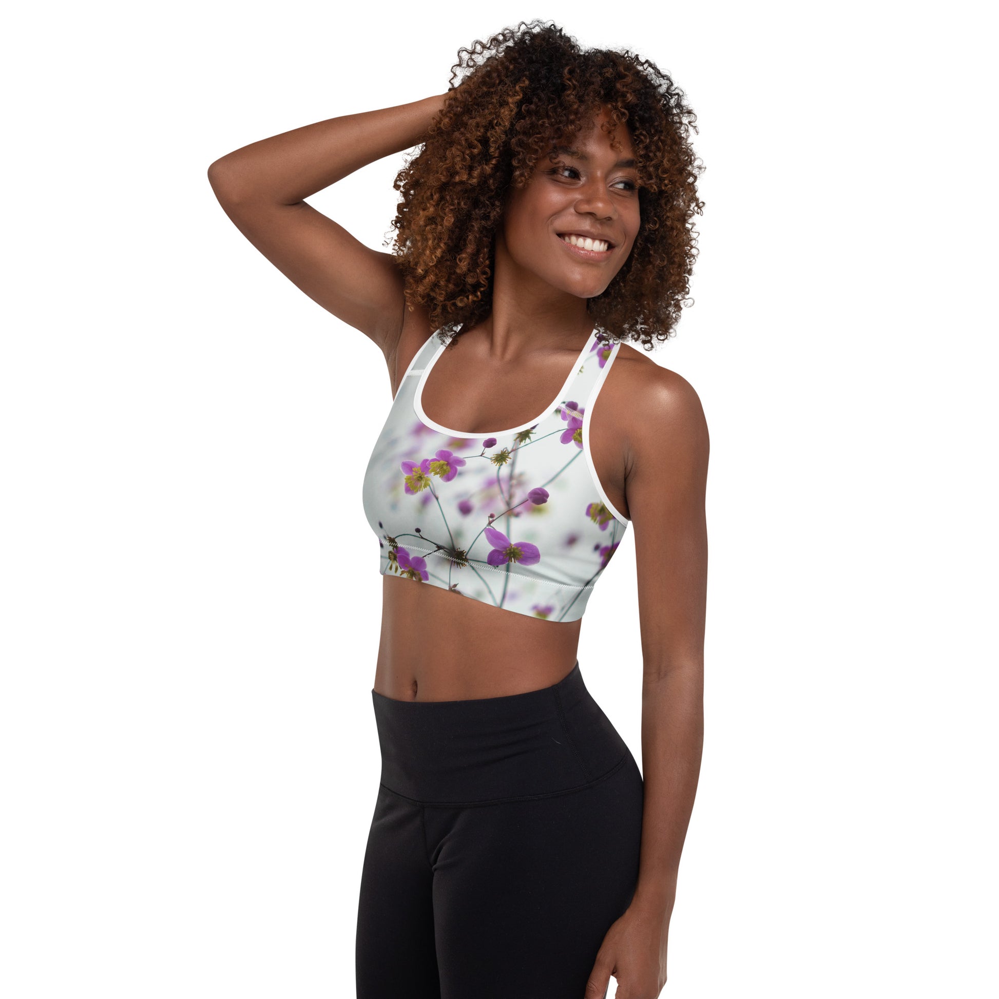 PJ Designs floral sports bra with padding featuring purple flowers on white background worn by smiling woman
