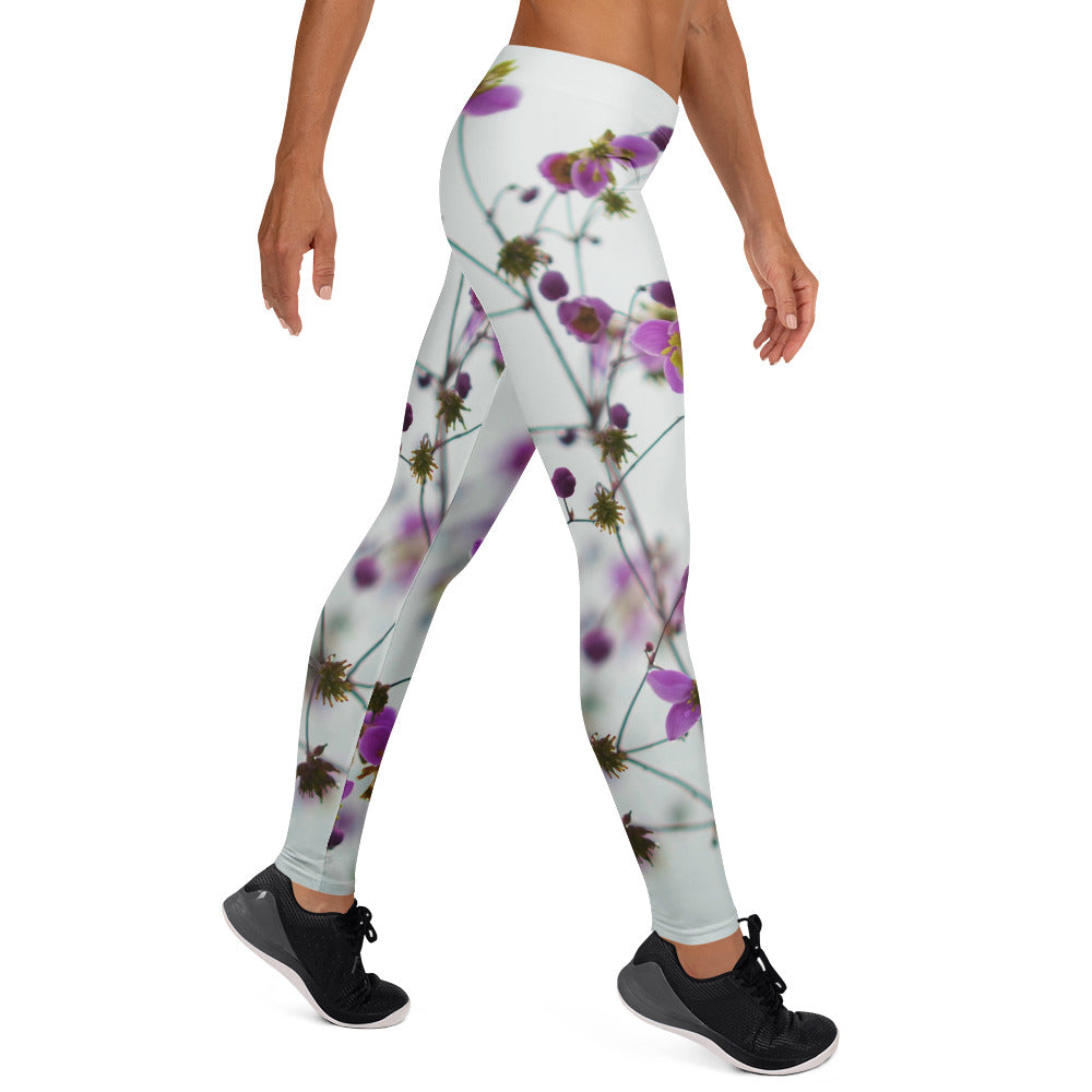PJ Designs flower print yoga pants with purple floral design worn by a woman in black sneakers