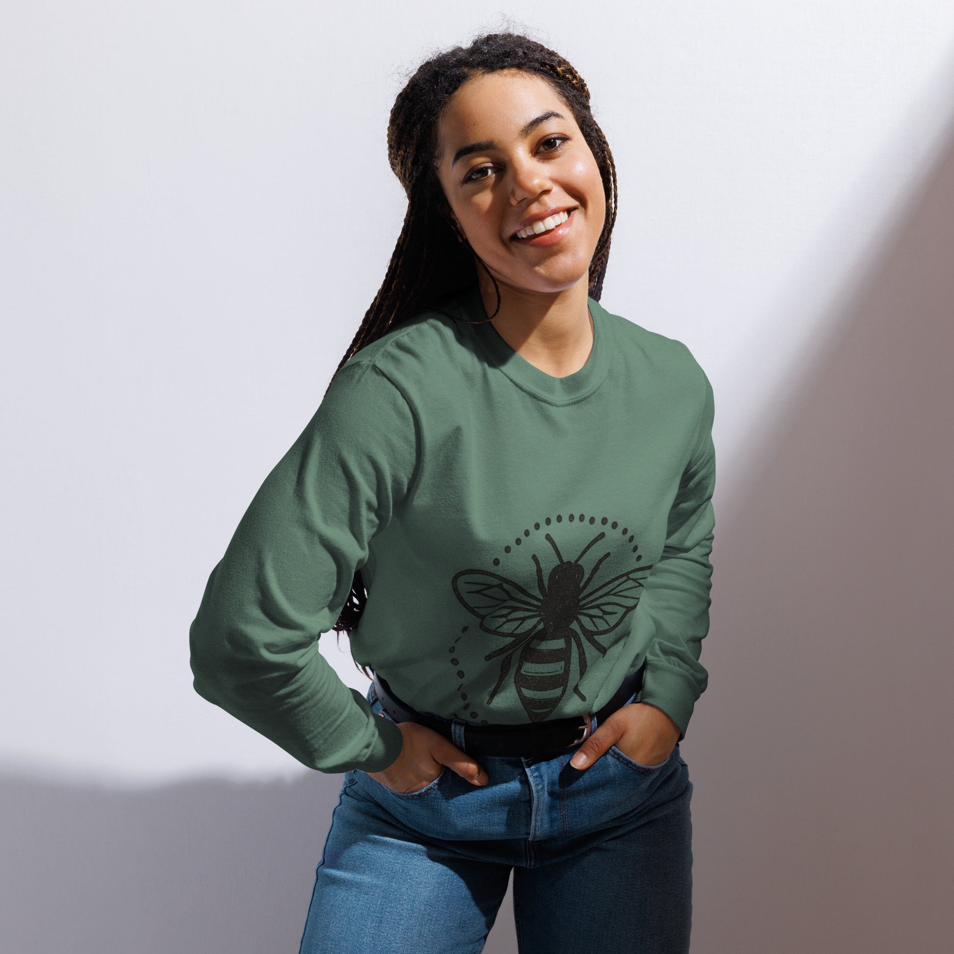 PJ Designs garment-dyed heavyweight long sleeve shirt in green with bee graphic worn by smiling woman