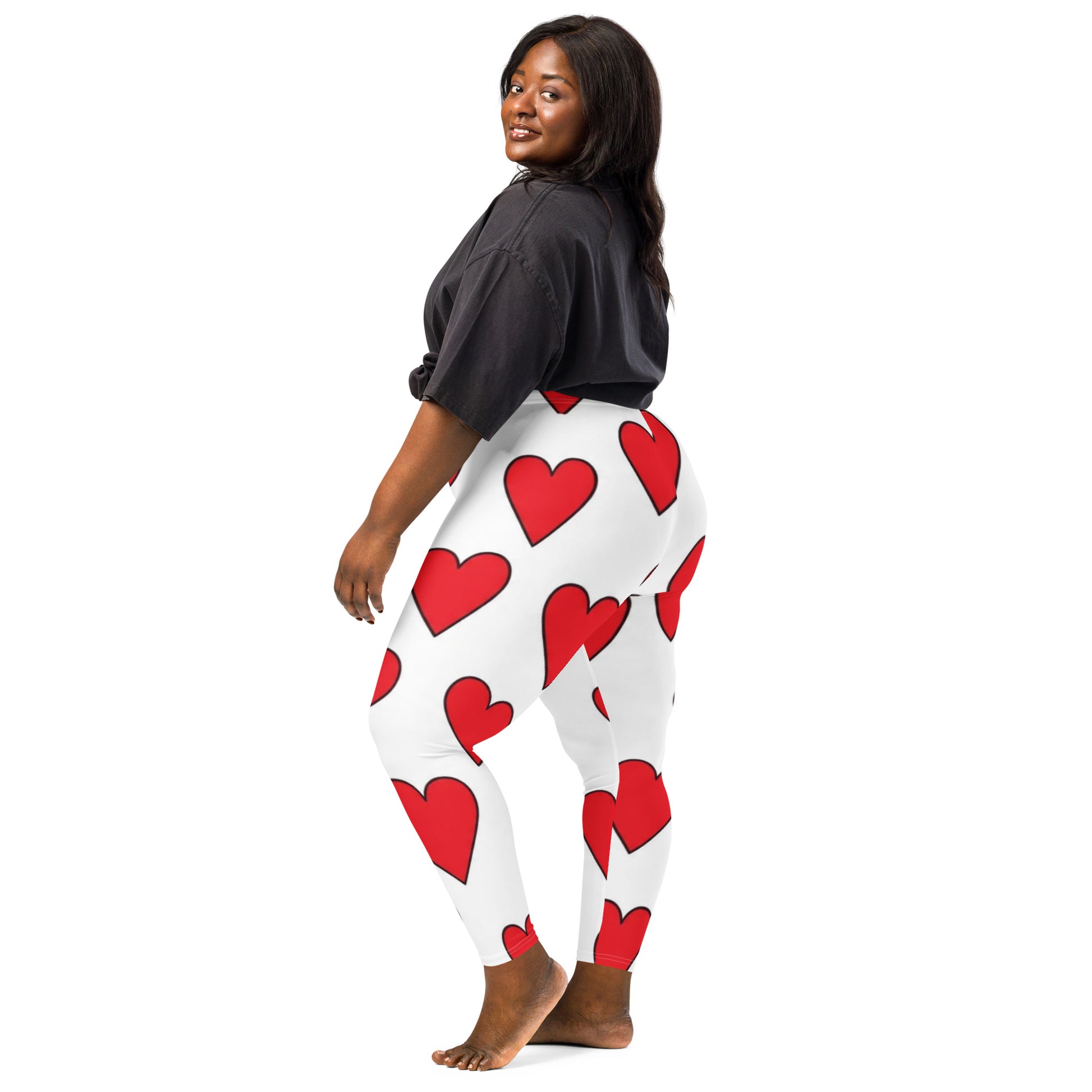 PJ Designs heart print leggings with large red hearts on white background worn by smiling woman