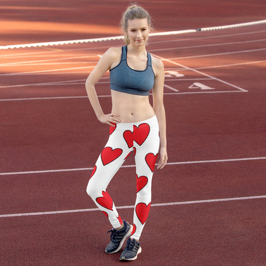 PJ Designs heart print leggings with large red hearts on white background worn by woman on running track