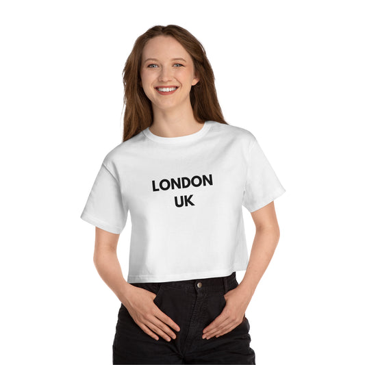 PJ Designs London inspired cropped t-shirt in white worn by smiling woman with black pants