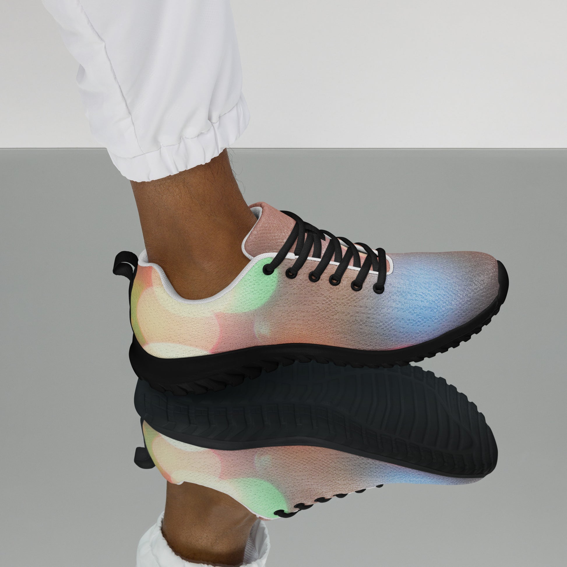 PJ Designs men's colorful running sneakers with gradient all over prints and black laces on model's foot