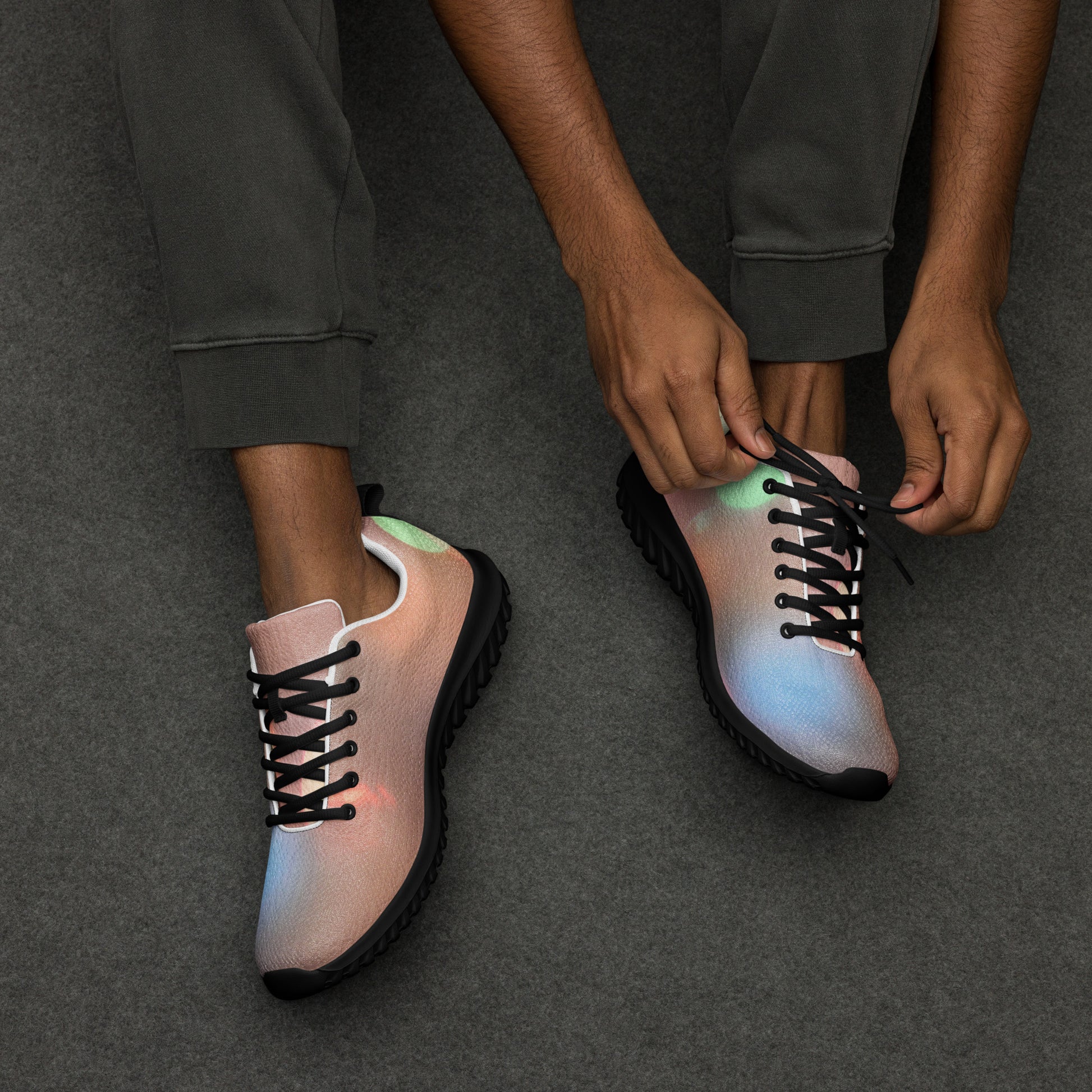 Men's colorful running sneakers by PJ Designs with black soles and laces on gray surface