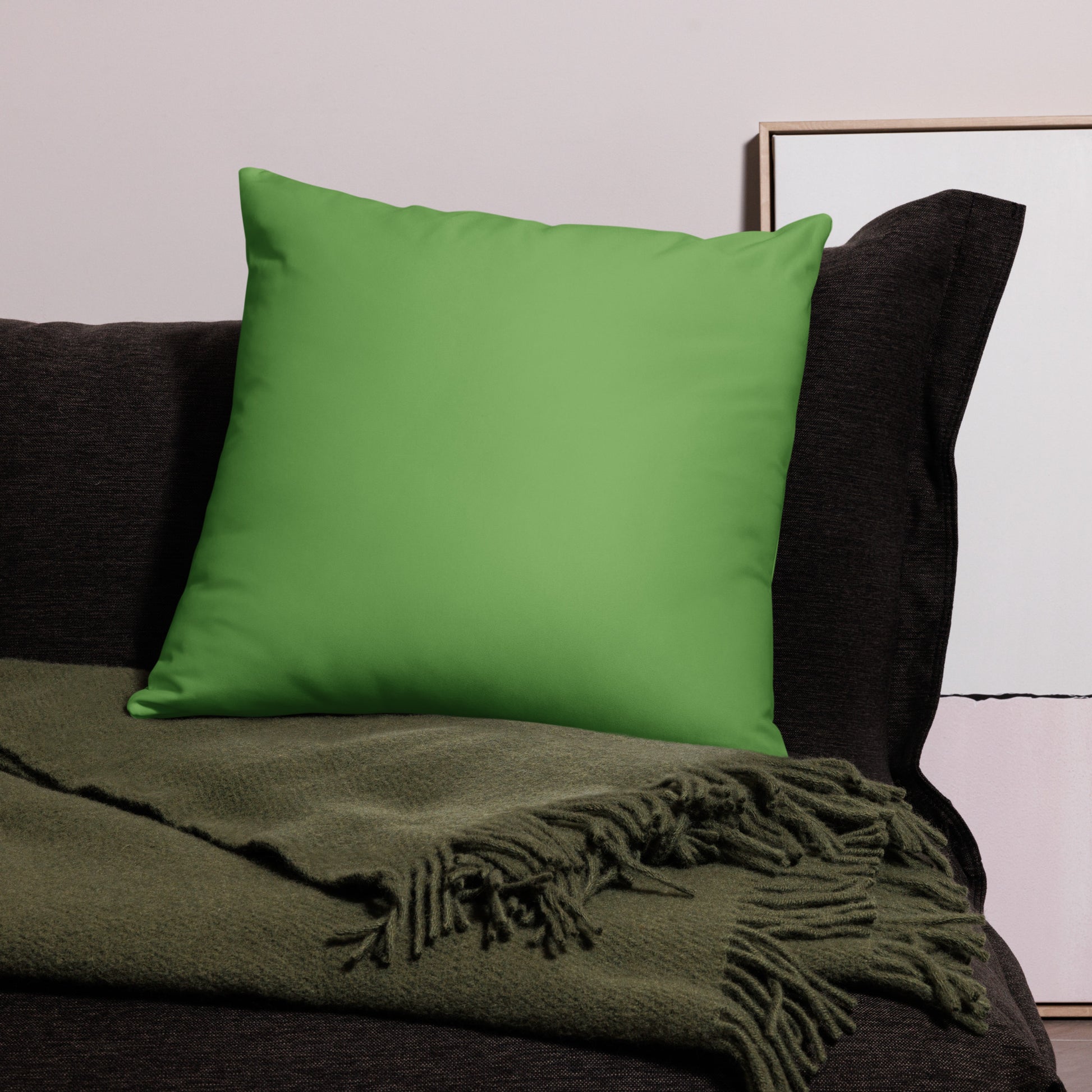 PJ Designs modern dove print cushion cover on green pillow with dark sofa and green throw blanket