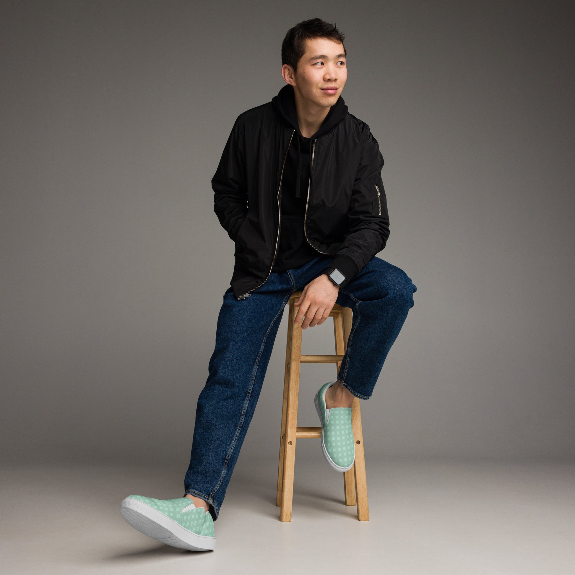 PJ Designs stylish canvas sneakers for men in light green worn with casual jeans and black jacket