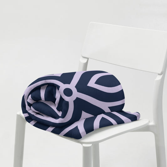 PJ Designs stylish cozy blankets for living room in navy and lavender geometric pattern folded on white chair