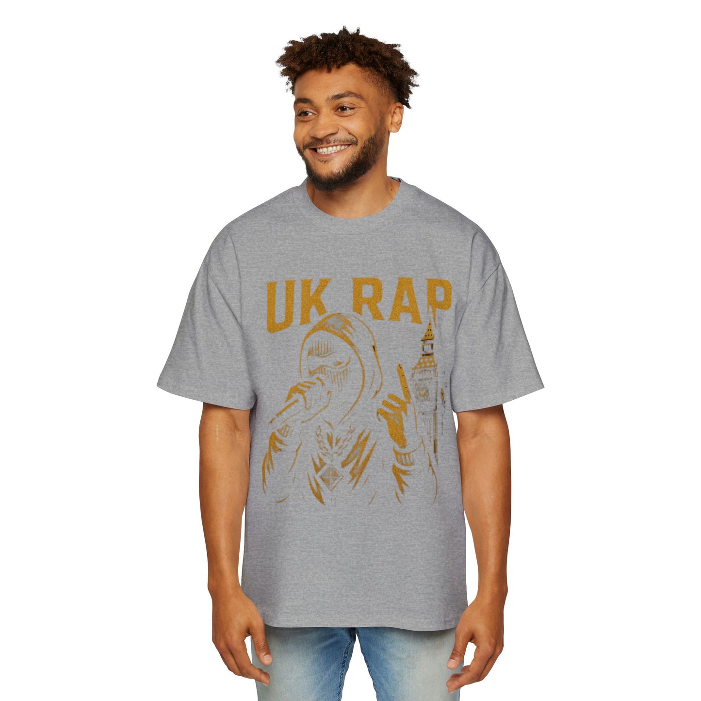 Gray UK rap oversized tee with gold graphic of rapper and cityscape worn by smiling man