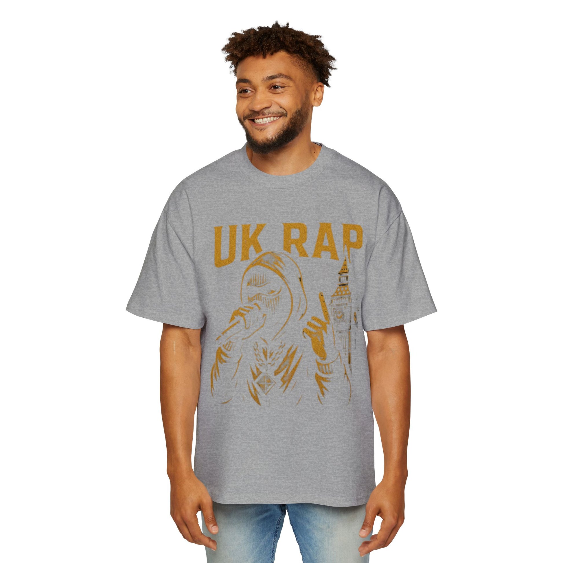 Gray UK rap oversized tee with gold graphic of rapper and cityscape worn by smiling man