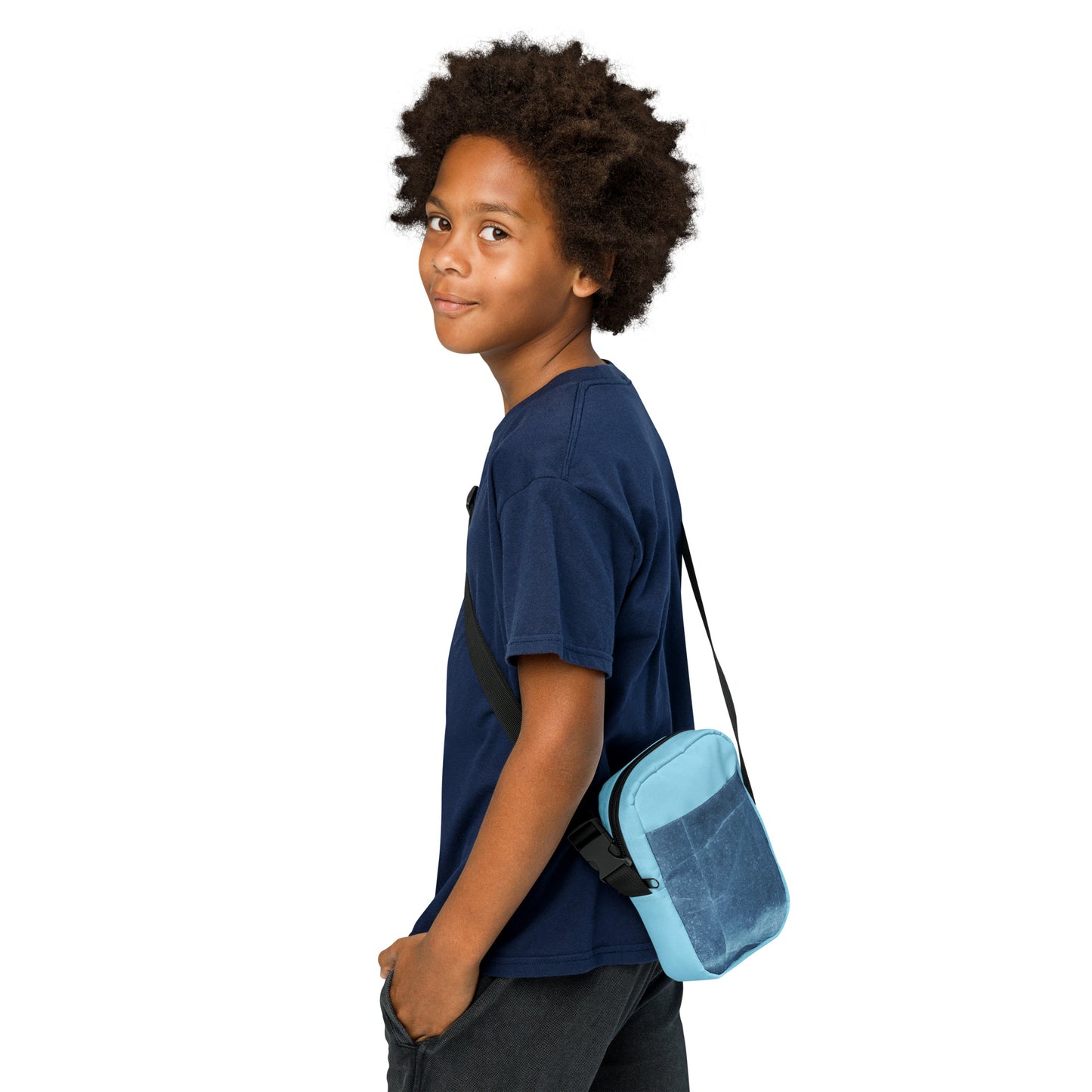 PJ Designs light blue unisex streetwear bag worn crossbody by young person in navy shirt