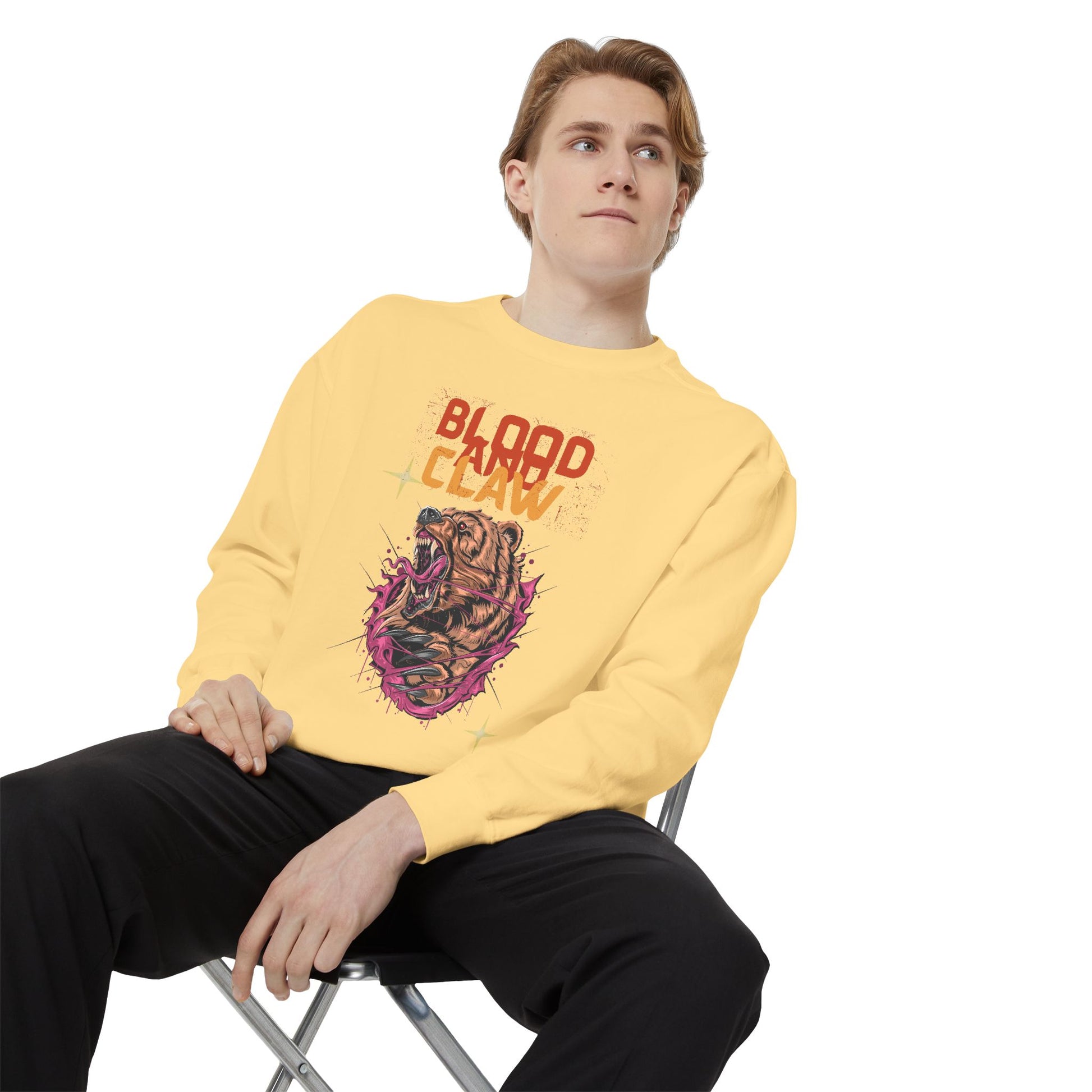Young man wearing Printify yellow unisex animal lover sweatshirt with Blood Claw snarling dog graphic