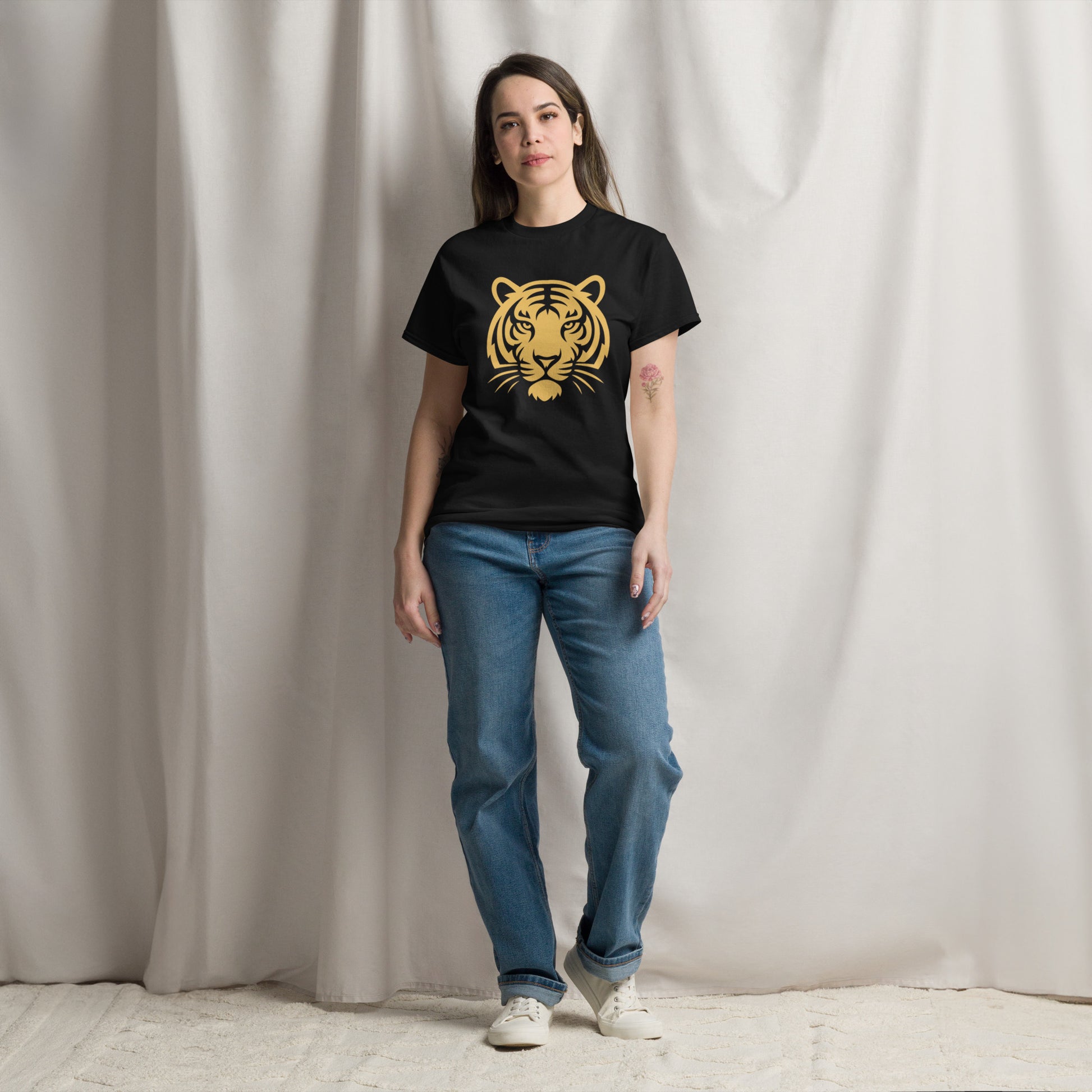 PJ Designs woman modeling black tiger graphic tee for men and women with gold tiger print jeans and sneakers
